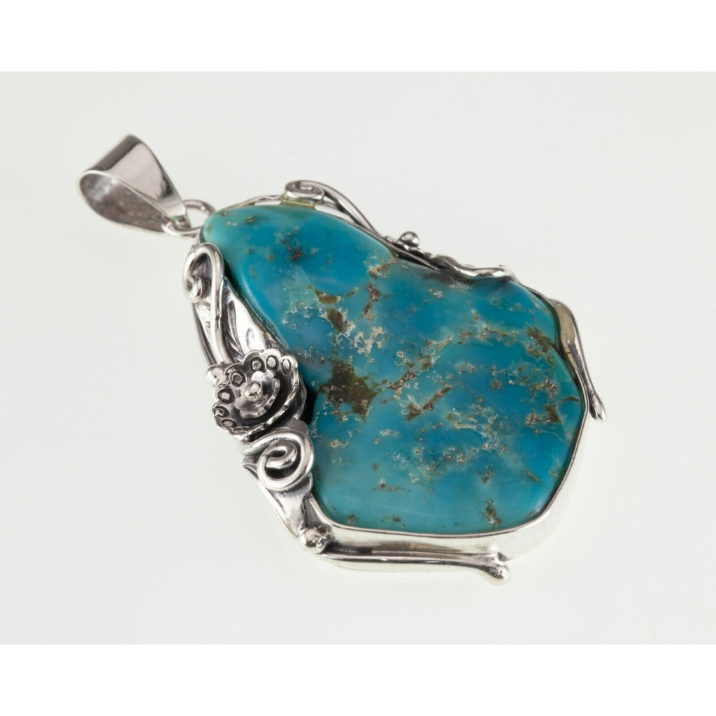 Amazing Turquoise Sterling Silver Pendant Set on a Floral Frame