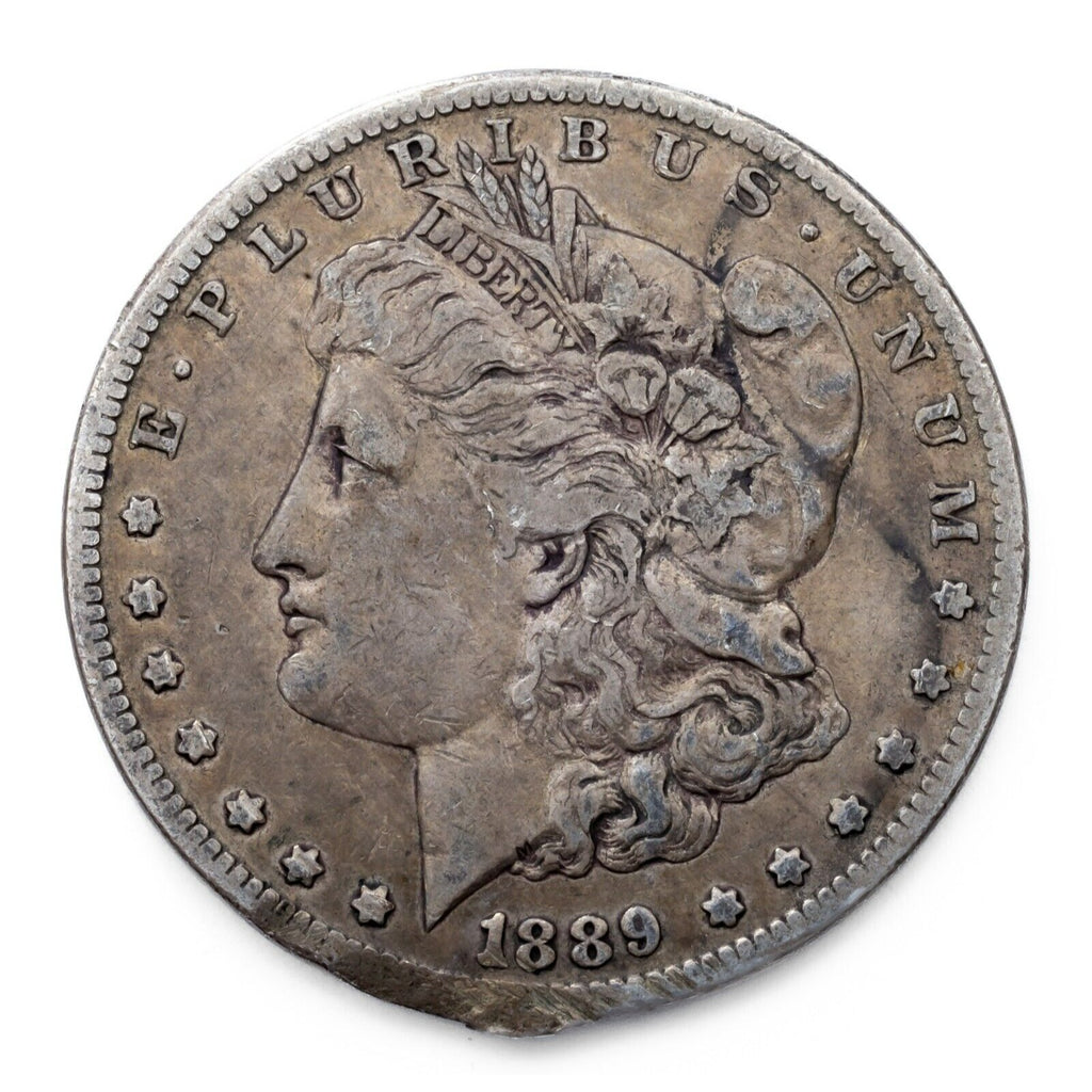 1889-CC $1 Silver Morgan Dollar in Fine Condition, VF in Wear, Rim Damage
